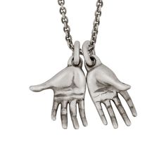 This exquisitely carved hands pendant comes on a sterling silver chain. Finished in oxidized sterling silver for a vintage, artisanal look. Solid 925 sterling silver.Oxidized matte finish.Each hand is approximately 0.4" x 1" (10 x 24 mm).24" chain in solid 925 sterling silver.Handcrafted in the USA. Antique Silver Hand Cast Sterling Silver Necklace, Hand Cast Antique Silver Sterling Silver Necklace, Hand Cast Sterling Silver Necklace In Antique Silver, Symbolic Hand Cast Sterling Silver Necklaces, Symbolic Hand Cast Sterling Silver Necklace, Symbolic Sterling Silver Necklace, Snake Bones, Precious Metal Clay Jewelry, Hand Pendant