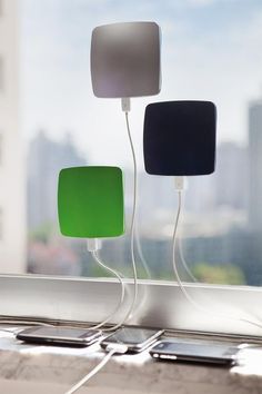 two square lights are plugged into the side of a window sill