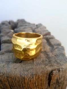 This is a beutifull 14 k gold plated brass, big noticeable ring. A rustic textured statement ring . it is a designer statement ring. A great gift for loved ones or for yourself. This stunning big 14 karat gold plated brass ring, is a very impressive piece. Its a chunky ring that makes a fashionable statement. The ring will look great with both casual & elegant wear. HANDMADE ITEM Materials: This ring is made of 14 karat gold plated brass. You can also choose between Sterling silver black oxi Handmade Gold Rings With Thick Band, Yellow Gold Brass Wide Band Ring Gift, Gold Wide Band Rings, Unique Hammered Gold Wide Band Ring, Unique Gold Hammered Wide Band Ring, Unique Gold Wide Band Round Ring, Elegant Handmade Wide Band Yellow Gold Ring, Elegant Handmade Thick Band Wide Ring, Elegant Handmade Yellow Gold Wide Band Ring