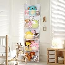 a child's room with stuffed animals and toys in the corner, including a crib