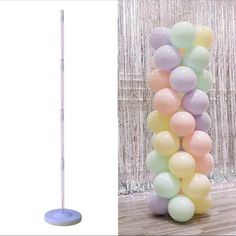 there is a tall balloon column with balloons on it and a white pole in the middle