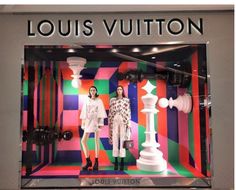 louis vuitton window display with two women in white dresses