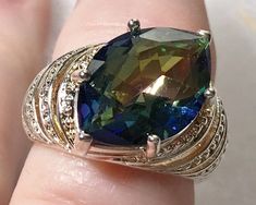 Stone: genuine fancy cut Blue Mystic Topaz, 18mm x 13mm Metal: Sterling Silver, Rhodium plated Size: 8.25 Luxury Multi-stone Topaz Ring In Sterling Silver, Smoky Topaz, Peridot Ring, Topaz Earrings, Mystic Topaz, Blue Band, Topaz Ring, Silver Blue, White Topaz