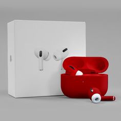 two red earbuds sitting next to each other in front of a white box