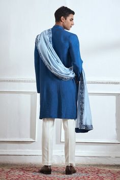 Blue kurta with contrasting floral hand embroidery around the placket. Comes with embroidered stole in a contrast color scheme and pyjama. - Aza Fashions Bollywood Style Blue Sherwani With Embroidered Border, Blue Bollywood Style Sherwani With Embroidered Border, Blue Embroidered Border Kurta For Wedding, Blue Embroidered Kurta For Wedding, Traditional Blue Kurta With Embroidered Sleeves, Eid Blue Unstitched Suit With Embroidered Border, Chanderi Traditional Wear With Embroidered Sleeves, Traditional Drape Wear With Embroidered Sleeves For Eid, Blue Sherwani With Embroidered Border For Festive Occasions