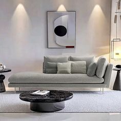 a modern living room with white walls and grey furniture in the center, along with an abstract painting on the wall