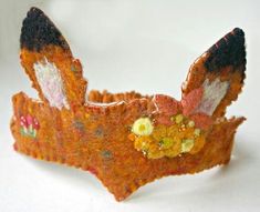 an orange and white headband with flowers on it