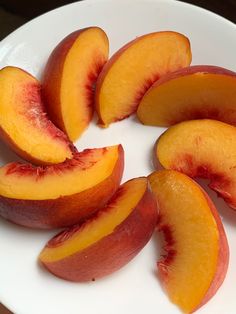 sliced peaches on a white plate ready to be eaten