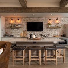 a kitchen with an island and lots of stools in front of the counter top