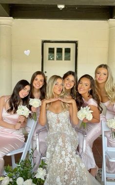 the bridesmaids are all dressed in pink dresses and holding bouquets with white flowers