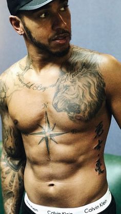 a shirtless man with tattoos on his chest