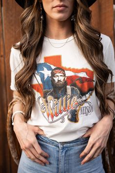 Now you can Remember The Good Times in this Midnight Rider x Willie Nelson Texas Tee! Proudly made in the USA, this Tried & True, 100% cotton tee has a vintage-inspired front graphic of Willie Nelson and The Lone Star State! Distressed hemlines help it age to pure perfection so grab your boots, your cowboy hat and top it off with this classic country favorite! Wear this oversized fit tunic as a dress or pair with a pair of distressed denim shorts. Super relaxed fit, size down if you want a more White Western Style T-shirt For Fall, Cotton Crew Neck T-shirt For Country Events, Fall Cotton T-shirt With Vintage Print, Western Cotton Tops For Country Festivals, Country Style White Graphic T-shirt, Vintage Cotton Tops For Rodeo, White Cotton Top For Country Events, White Cotton Tops For Country Events, Retro Crew Neck Tops For Western-themed Events