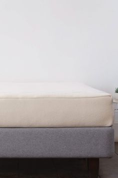 an image of a mattress that is in the middle of a bed with no sheets on it