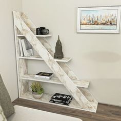 a white book shelf with books and cameras on it