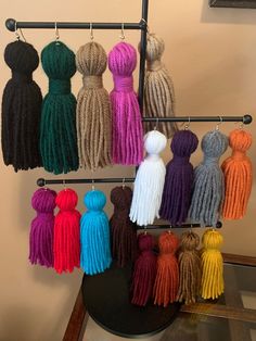 there are many different colored tassels hanging on the rack