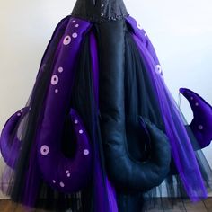 there is a purple and black costume on display