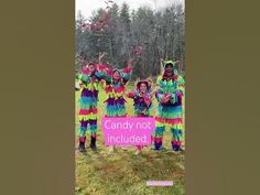 some people are dressed in colorful clothing and holding up a sign that says candy not included