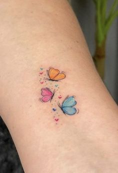 a small butterfly tattoo on the left side of the leg, which has hearts and butterflies all over it