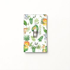 a light switch cover with jungle animals and leaves