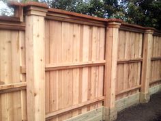 a wooden fence that is next to a tree