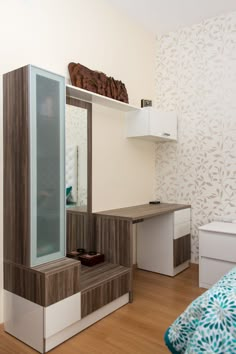 a room with a bed, desk and shelves on the wall next to each other