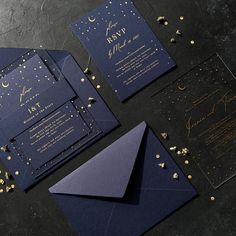 wedding stationery with gold confetti and navy blue paper on black background, including envelope