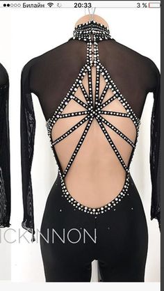 the back of a black bodysuit with white beads on it and an open neckline