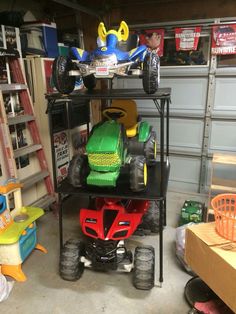 two toy cars are stacked on top of one another in a garage with other toys