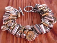 a close up of a bracelet on a wooden surface with lots of different types of buttons