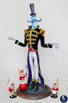 a figurine of a blue man in a top hat and costume with other toy figures