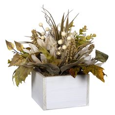 a white vase filled with lots of different types of flowers and leaves on top of a table