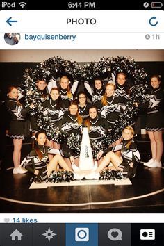 a group of cheerleaders posing in front of a christmas tree