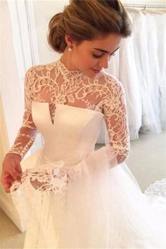 a woman in a wedding dress looking at her phone