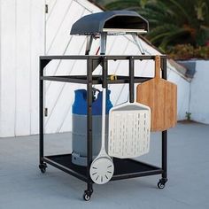 an outdoor grill with various cooking utensils on it