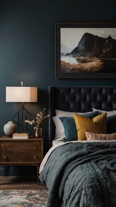 a bedroom with blue walls and a large painting on the wall above the headboard