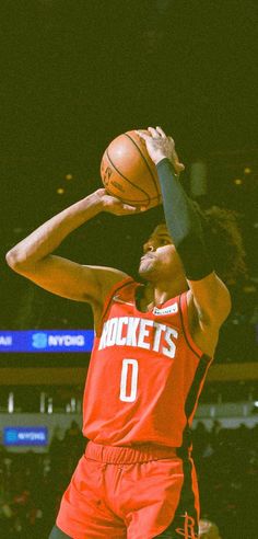 the basketball player is getting ready to dunk the ball