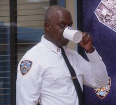 a police officer is drinking from a cup