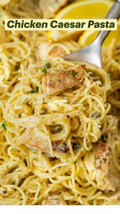 chicken and pasta in a skillet with lemon wedges