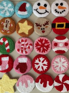 several christmas themed buttons are arranged on a white surface with snowflakes and santa's hats