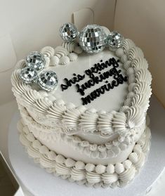 a heart shaped cake with the words happy birthday written on it and disco balls in the shape of a heart