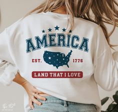 the back of a woman's white sweatshirt that says america, land that i love