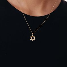 The Star of David Necklace in 14K Gold is a stunning piece of jewelry that beautifully showcases your faith. Made from 14k solid gold. This necklace serves as a meaningful symbol of your beliefs and is a great gift for yourself or a loved one. Stand out with this elegant and meaningful necklace that effortlessly combines style and spirituality. 14k solid gold handcrafted necklace 100% ethical sourced jewelry Material: 14k Solid Gold Pendant Height: 16 mm / 0.61 inch Pendant Width: 13 mm / 0.51 i Star Of David Gold Necklace, Jewish Star Necklace, Star Of David Necklace, Meaningful Necklace, Jewish Star, 14k Gold Necklace, Handcrafted Necklace, Star Of David, Recycled Gold