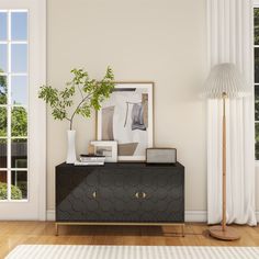 a living room scene with focus on the sideboard and plant in front of the window