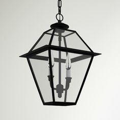 an old fashioned hanging lantern with two candles