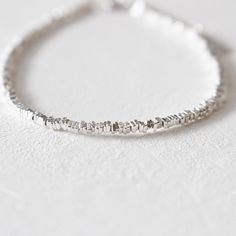 SPARKLING CHAIN SILVER BRACELET  This stunning handcrafted minimalist bracelet features a minimal concept that is perfect for you or as a gift for her on any occasion. The timeless and elegant of this silver bead bracelet is a beautiful accent to any outfit. Our delicate braceletis designed with a focus on minimalist aesthetics and timeless charm. This dainty bracelet combines the elegance of a solid silver chain with the brilliance of chain design, making it a must-have in your stackable bracel Modern Silver Beaded Bracelet As Gift, Adjustable Modern Sterling Silver Chain Bracelet, Modern Adjustable White Gold Beaded Bracelets, Minimalist Nickel-free Bracelet, Modern Sterling Silver Bracelets For Everyday, Minimalist Nickel-free Chain Bracelet For Everyday, Minimalist Handmade Silver Beaded Bracelets, Simple Handmade Silver Bracelets, Minimalist Everyday Nickel-free Chain Bracelet