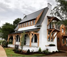 a white house with wood trim and windows