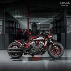 a red and black motorcycle parked in a garage