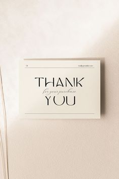 a thank card with the words thank you written in black ink on a white background