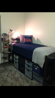 a bedroom with a bed and storage bins