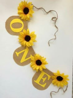 sunflowers and burlap banner with the word love spelled out on it